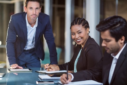 Portrait of businessman and businesswoman sitting in a meeting in the conference room-3