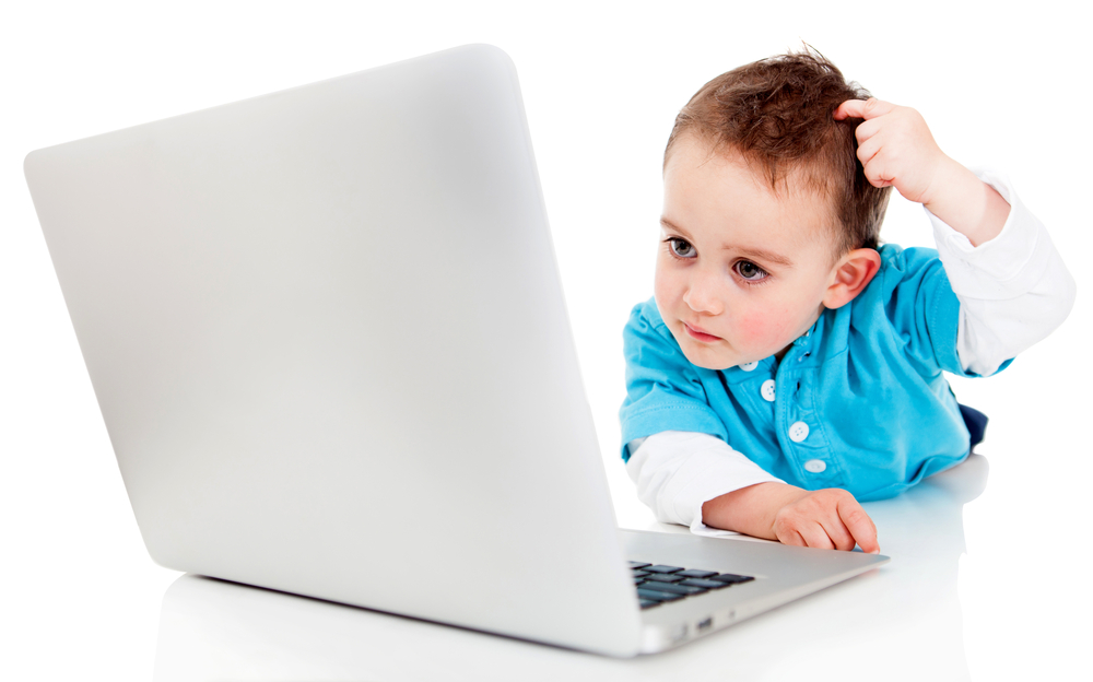 Confused boy with a laptop computer - isolated over a white background